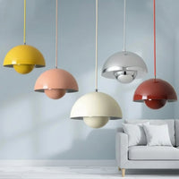 Colorful pendant lights hanging above a sofa with a neutral background