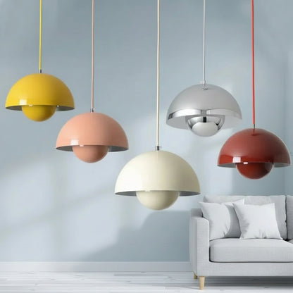 Colorful pendant lights hanging above a sofa with a neutral background
