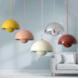 Colorful pendant lights hanging above a sofa with a neutral background